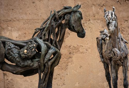 A close up of the two cork driftwood horse sculptures